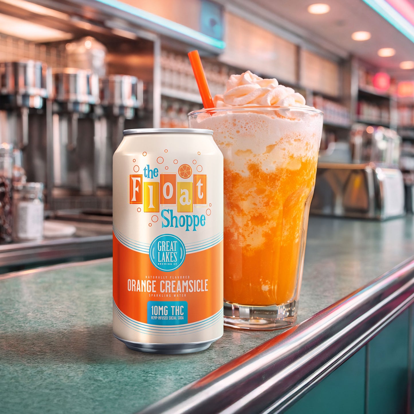 Can of 'The Float Shoppe' Orange Creamsicle flavor on a counter with a matching drink.